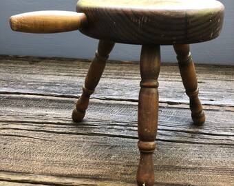 Rustic wooden milking stool with handle