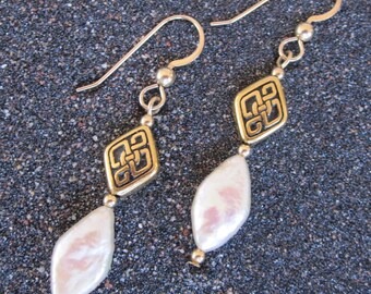 Diamond-shaped peach freshwater pearl and Celtic bead earrings with gold-filled earwires and accent beads.
