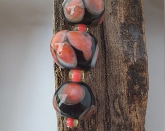 Black and coral glass lampwork beads