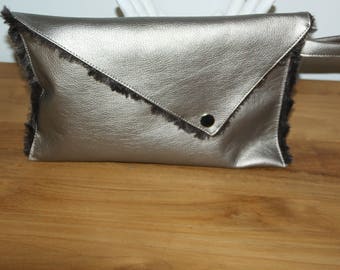 Cover has asymmetrical flap in faux leather and faux fur.