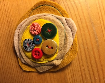 Wool felt designer brooch with a selection of buttons
