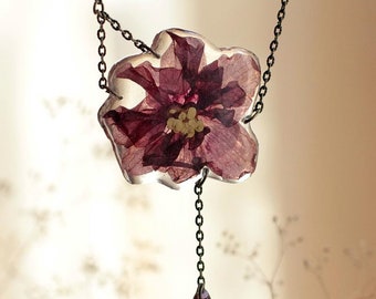 Pendant with a flower of a violet
