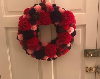 Large round pompom wreath in shades of red