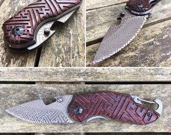 Folding knife with sacred geometric pattern engraving