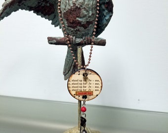 Heartsongs - Stand Up for Jesus is an altered wood poker chip with paper hymn snippets, metal findings and charms