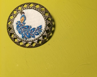Peacock brooch, stamped and hand embroidered. 3 x 3 cm