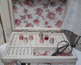 Handmade vintage sewing box with six drawers, spool holders and storage tray. Lined in antique French fabric and painted in antique white.