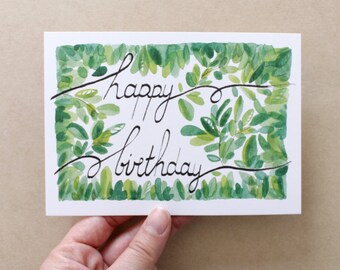 HAPPY BIRTHDAY. Calligraphic card and foliage. Elegant and vegetal card. Watercolor.