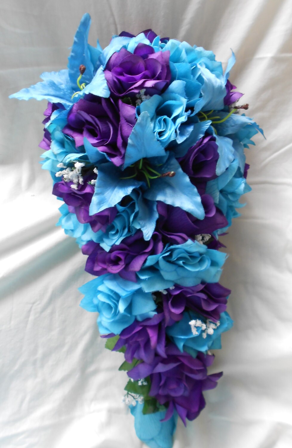 purple and turquoise blue cascade wedding bouquet lilies and purple and blue flowers