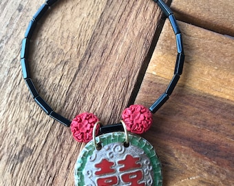 Black and red beaded choker with Asian pendant