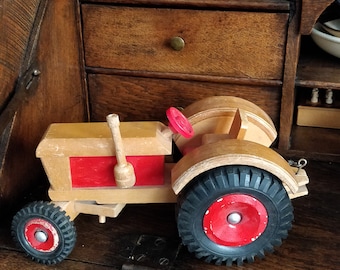 Vintage wooden tractor with rubber wheels and working handlebars