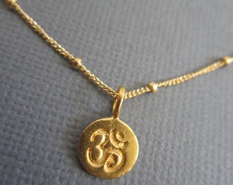 Om Necklace, Tiny Om pendant necklace, Gold Om charm on 14K Goldfill Satellite Chain. Visit Lotus411 more buddhist jewelry.