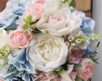 Pastel wedding bouquet in pale blue, blush pink and ivory. Made with artificial roses, peonies, stocks and hydrangea.