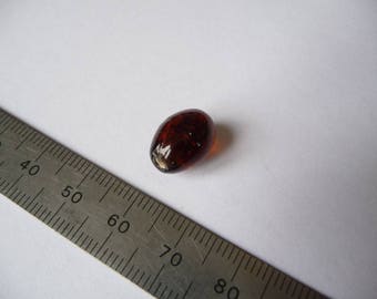 A dark orange bead 13 x 10 mm