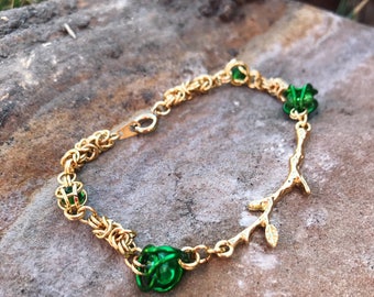 Gold and green chainmaille bracelet with gold tree branch
