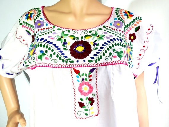 White bohemian dress with Mexican embroidery.
