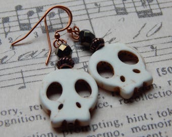 White magnesite skull-shaped earrings.