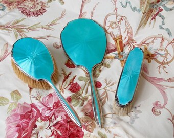 A glamorous 1920s antique sterling silver and guilloche enamel turquoise dressing table or vanity set