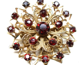 60s Rhinestone brooch, Filigree with garnet glass, star/flower design. 1.25".