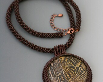 Beaded bezel polymer clay pendant on a chenille stitch necklace. Green necklace. Brown necklace. Glass, leather, ultrasuede.