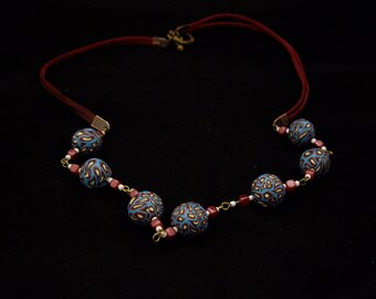 Polymer clay beaded necklace with Czech glass beads.