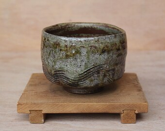 Asymmetrical tea bowl with thin shino glaze