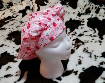 Bouffant style scrub cap. Pink and white checkered Hello Kitty. elastic and Cord lock in the back.