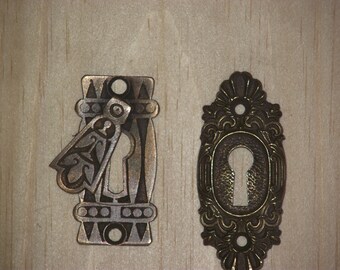 Four antique brass escutcheons from the very early 1900's.