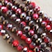 Set of 50 beads shaped 6 x 4 mm faceted glass: red/copper.