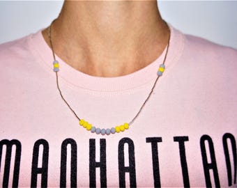 ethnic woman in yellow-gray faceted beads necklace