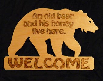 An old bear and his honey live here - Welcome sign