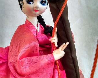 Beautiful Pose Doll Swinging on Cherry Blossom Branch