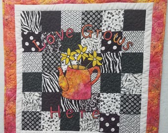 Love Grows Here wall hanging