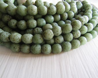Round lampwork glass beads, rustic green with brown wash, opaque matte gritty textured aged look indonesian 9 to 10mm (12 bead)7ab12-1