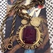 Vintage 1950s Necklace Red Glass Cameo Style Medallion Pendant With Coins By Cupri Gold Tone Color Metal