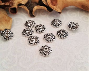 10 round cups 4 small petals made of antiqued, silver hearts formed Clematis