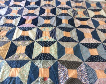 Great colors! Antique/vintage indigo blue and orange spool or bow tie quilt top. Measures 51"x 78".