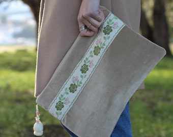 Handmade, beige-toned Clutch with floral embellishment.