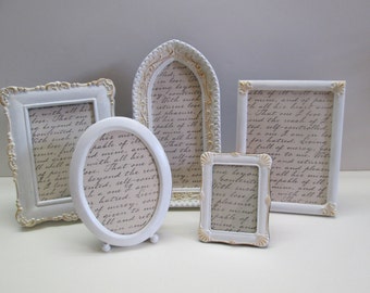 Collection of assorted shape white painted frames for family photos, shabby decor, weddings