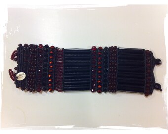 Its striking Swarovski black wrist band cuff, ROSAMUNDA-Garnet and bourdeaux-new