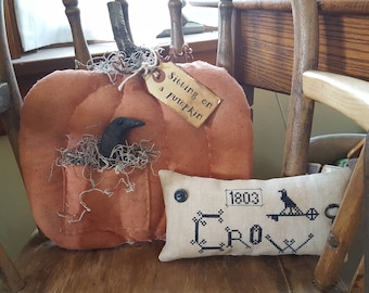 Sitting on a pumpkin - primitive pumpkin with crow in a pocket shelf sitter/door hanger