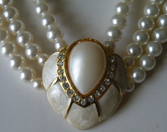 Faux pearl, enamel, rhinestone three strand necklace.