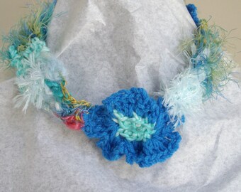 Blue and white crocheted necklace with crocheted flower