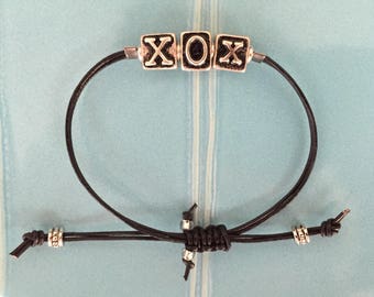 XO hugs and kisses bracelet on black leather cord