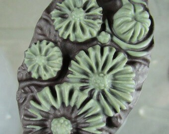 Carved ribbon jasper floral pendant
