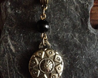 Small brass shield with Onyx bead pendant