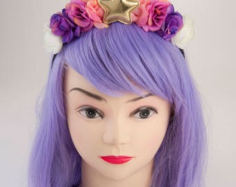 Pink and purple unicorn horn with sprinkles and flowers