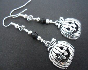 A pair of hand made pumpkin tibetan silver dangly halloween earrings.