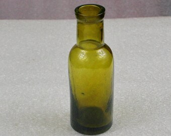 Green Antique glass bottle , medical or laboratory bottle . Vintage medical glass bottle