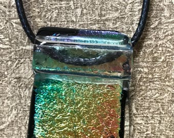 Dichroic glass pendant on black cord